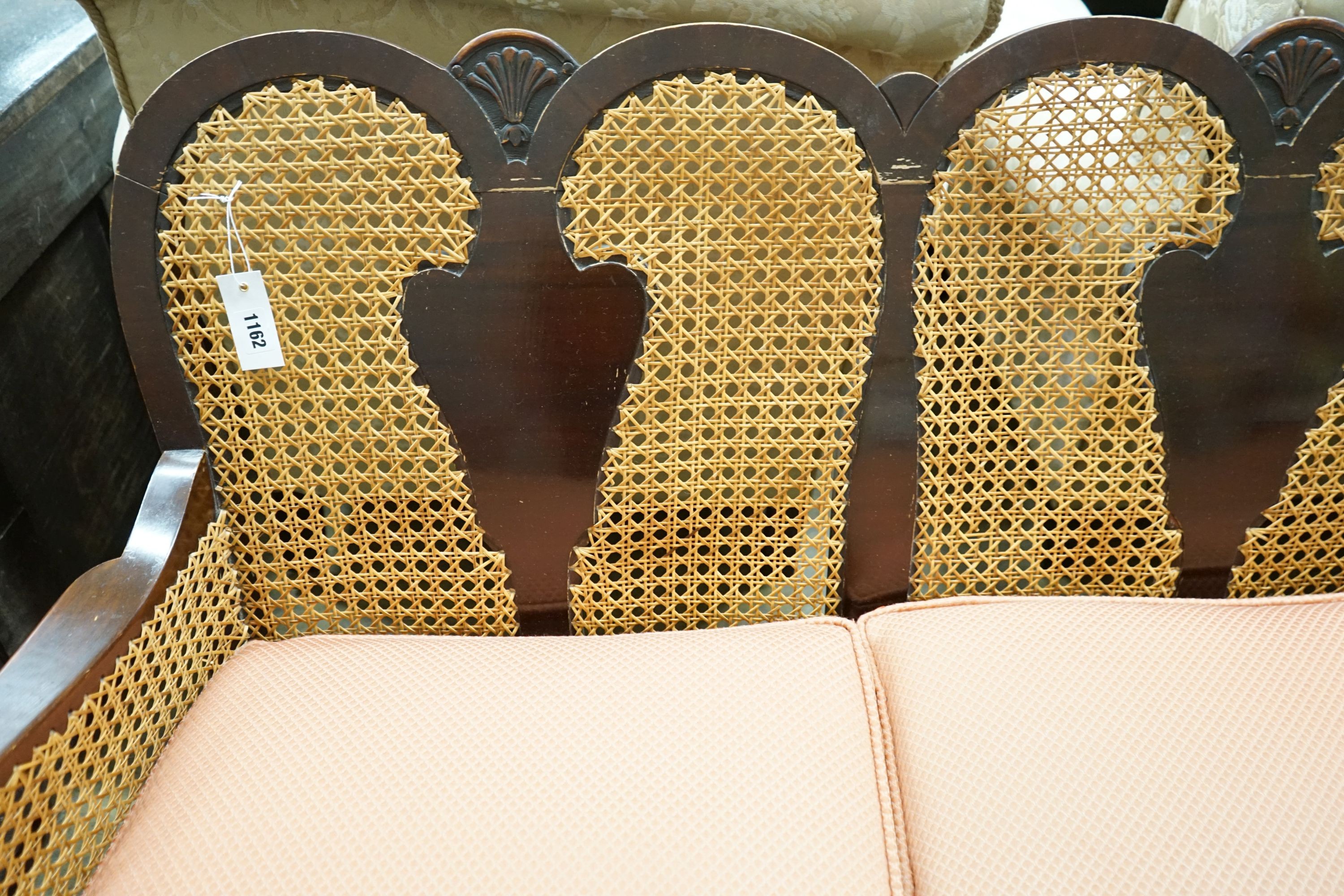 A 1920's caned beech two piece bergere suite, sofa length 167cm, depth 178cm, height 80cm